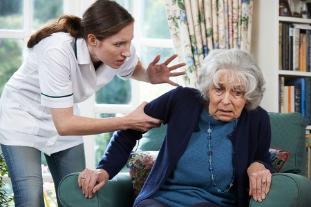 nursing home employee grabbing arm of a woman who resides in a nursing home